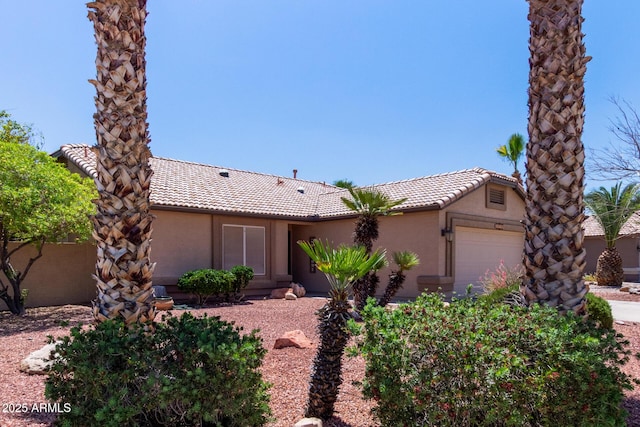 20769 N 106th Ln, Peoria, AZ 85382 - view of front of house with a tile roof, an attached garage, and stucco siding