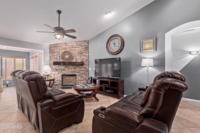 20769 N 106th Ln, Peoria, AZ 85382 - living area with lofted ceiling, a ceiling fan, light tile patterned floors, and a stone fireplace
