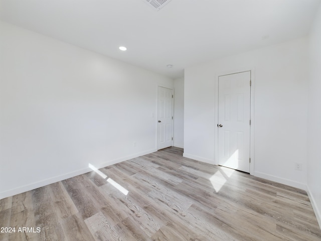 spare room featuring light hardwood / wood-style flooring