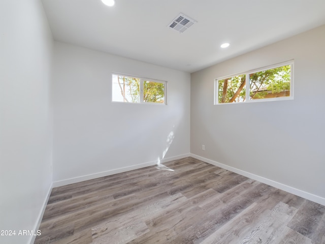 unfurnished room featuring a healthy amount of sunlight and light hardwood / wood-style floors