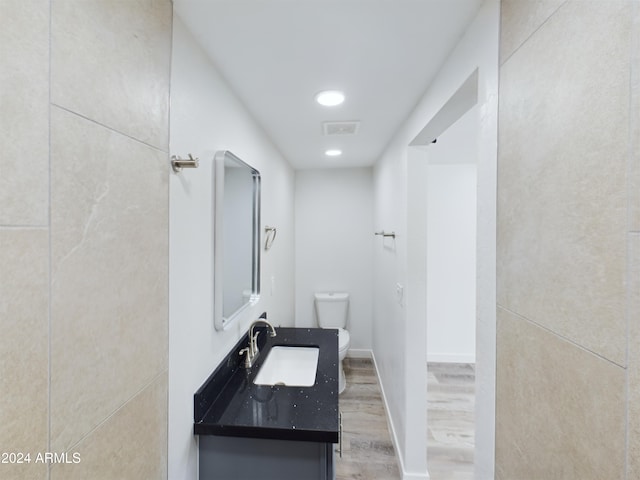 bathroom with hardwood / wood-style flooring, sink, and toilet