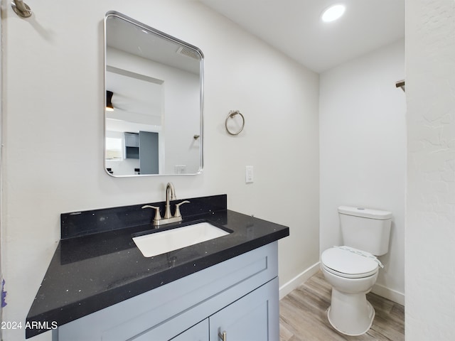 bathroom featuring hardwood / wood-style flooring, vanity, and toilet