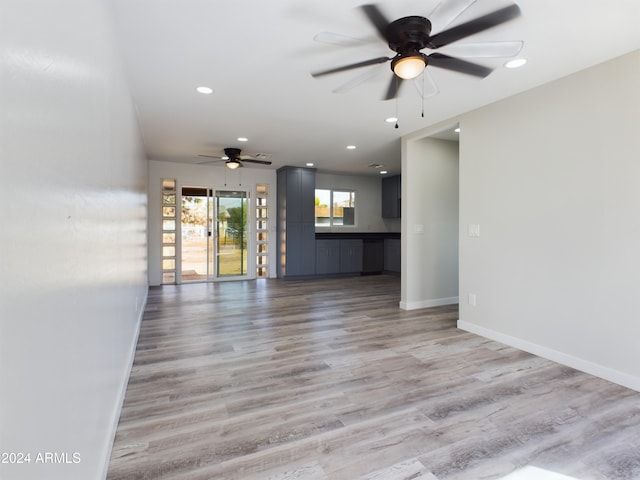 unfurnished living room featuring light hardwood / wood-style floors and ceiling fan