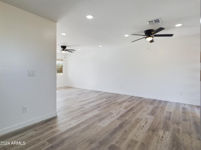 spare room with light hardwood / wood-style flooring and ceiling fan