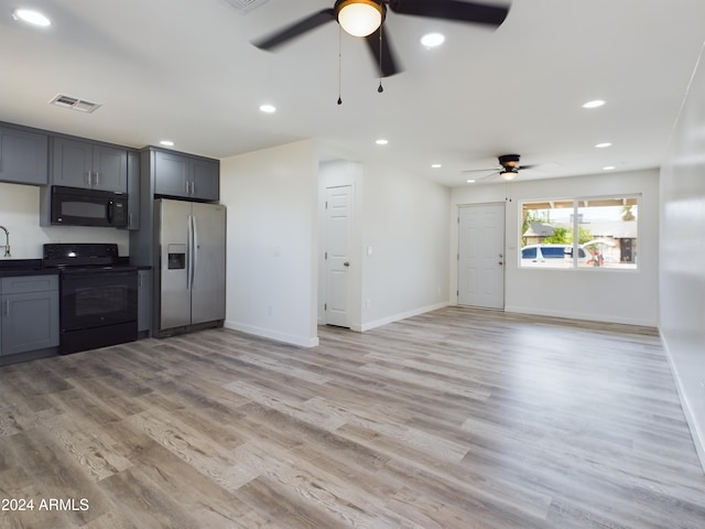 kitchen with gray cabinets, ceiling fan, light wood-type flooring, and black appliances