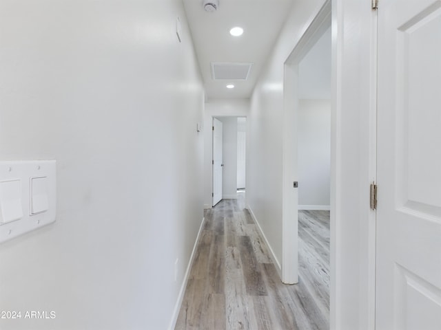 corridor with light hardwood / wood-style floors