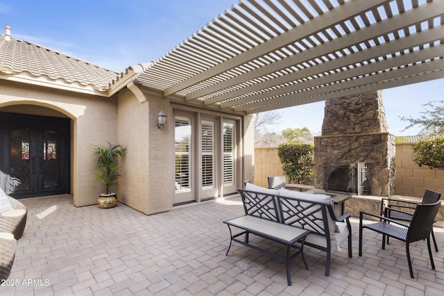 view of patio with an outdoor living space with a fireplace and a pergola