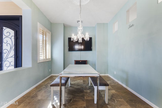 dining space featuring a notable chandelier