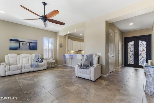 living room featuring ceiling fan and french doors