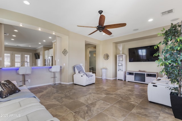 living room featuring crown molding and ceiling fan