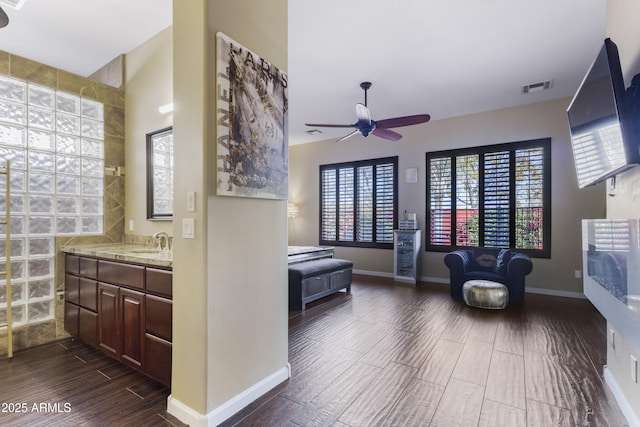 interior space with ceiling fan and vanity