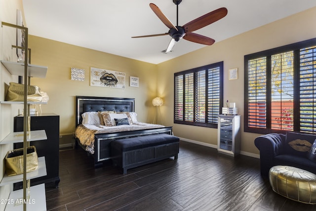 bedroom with dark hardwood / wood-style floors and ceiling fan