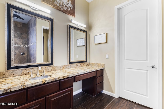 bathroom with vanity, wood-type flooring, and walk in shower