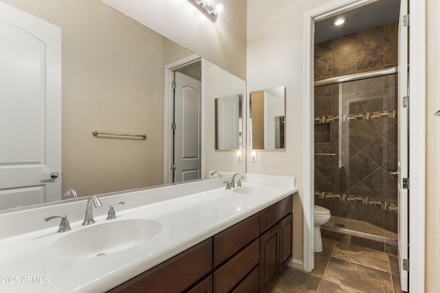 bathroom featuring vanity, toilet, and walk in shower