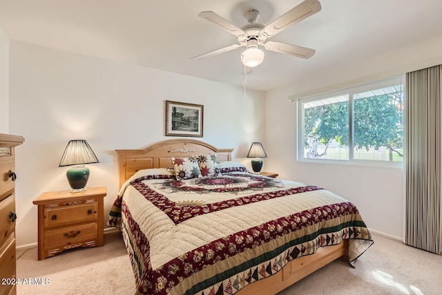 bedroom featuring ceiling fan and light colored carpet