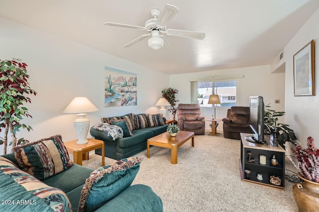 carpeted living room with ceiling fan