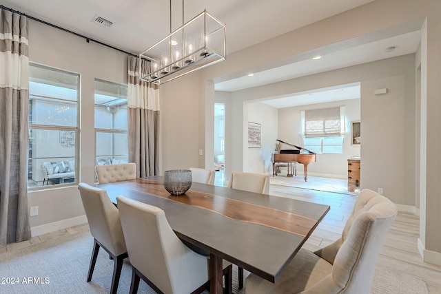 dining space with light hardwood / wood-style floors