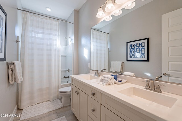 full bathroom with vanity, shower / bath combo with shower curtain, and toilet