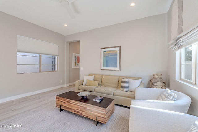 living room with ceiling fan and light hardwood / wood-style floors