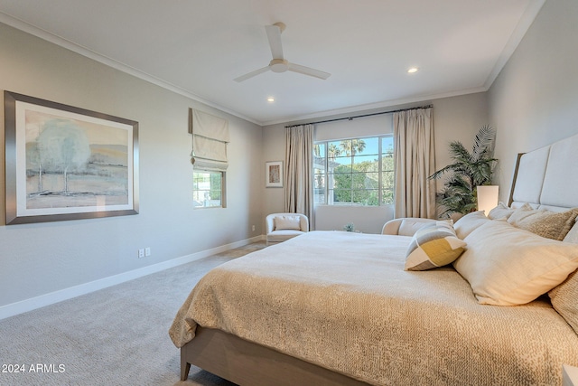 carpeted bedroom with ceiling fan and ornamental molding