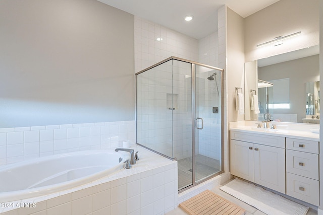 bathroom with vanity, independent shower and bath, and tile patterned flooring