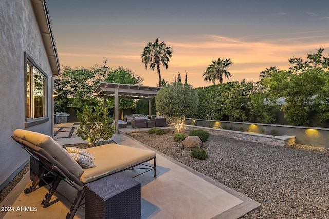 patio terrace at dusk with outdoor lounge area and a pergola