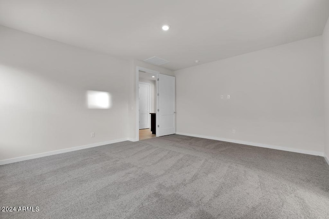 carpeted empty room featuring baseboards and recessed lighting
