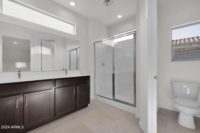 bathroom featuring a stall shower, toilet, tile patterned floors, double vanity, and recessed lighting