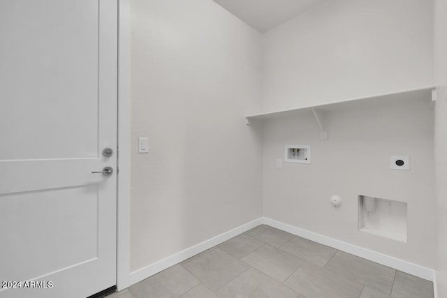 laundry room featuring washer hookup, electric dryer hookup, gas dryer hookup, baseboards, and light tile patterned flooring
