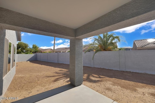 fenced backyard with a patio area