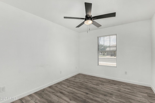 empty room featuring wood finished floors, baseboards, and ceiling fan