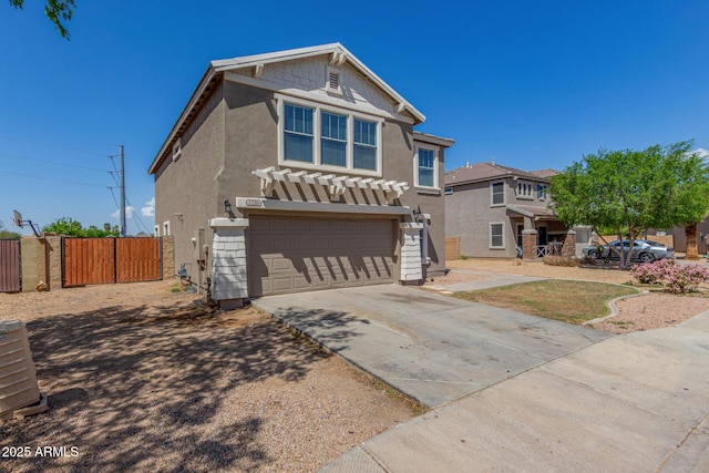 traditional-style home featuring stucco siding, an attached garage, fence, and driveway