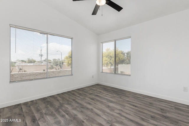 spare room featuring a ceiling fan, dark wood-style flooring, baseboards, and vaulted ceiling