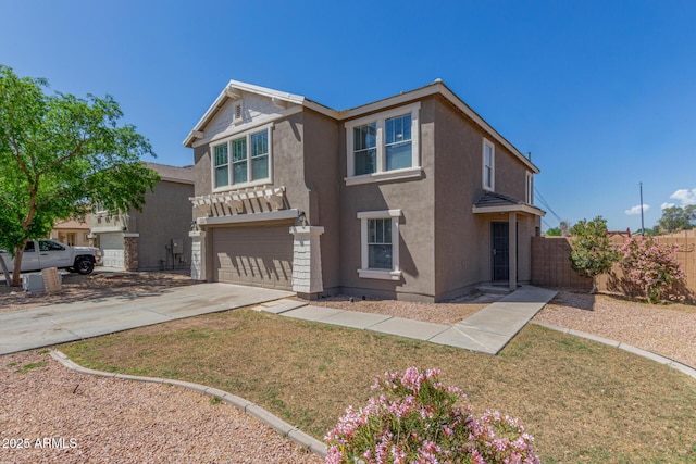 traditional-style home featuring stucco siding, an attached garage, fence, and concrete driveway