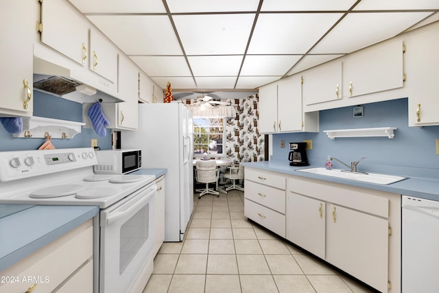 kitchen with white appliances, sink, ceiling fan, light tile patterned floors, and white cabinetry