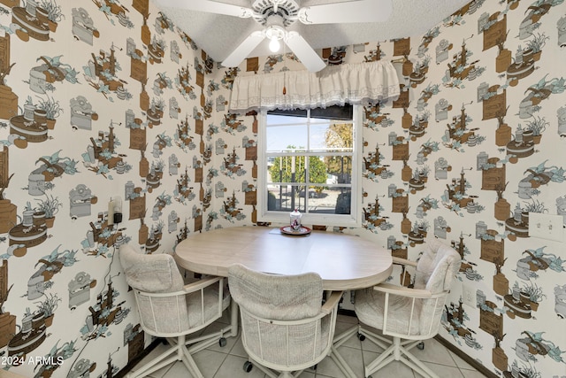 tiled dining room featuring ceiling fan and a textured ceiling