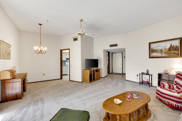 living room with ceiling fan with notable chandelier, a textured ceiling, and light colored carpet