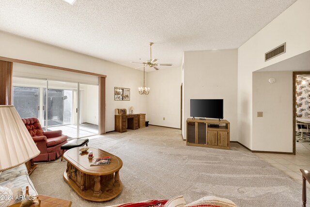 tiled living room featuring ceiling fan and a textured ceiling