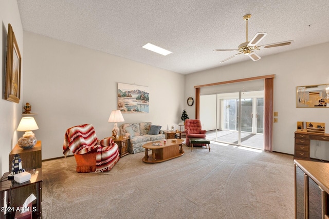 living area with light carpet, a textured ceiling, and ceiling fan