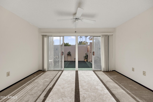 unfurnished room featuring carpet flooring, a textured ceiling, and ceiling fan