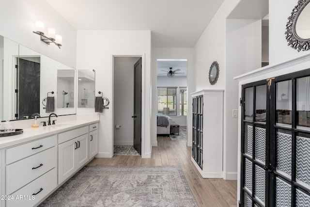 bathroom featuring ceiling fan, hardwood / wood-style floors, and vanity