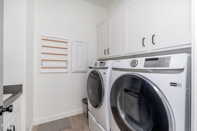 laundry room with cabinets, separate washer and dryer, and light hardwood / wood-style flooring