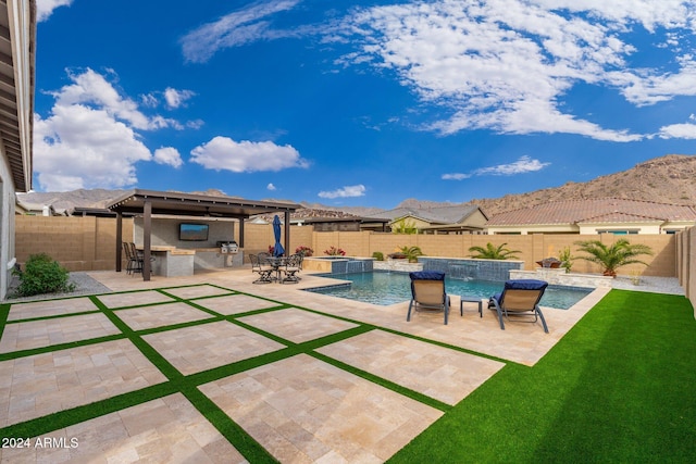 view of pool featuring area for grilling, pool water feature, a bar, and a patio