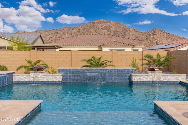 view of pool featuring pool water feature and a mountain view