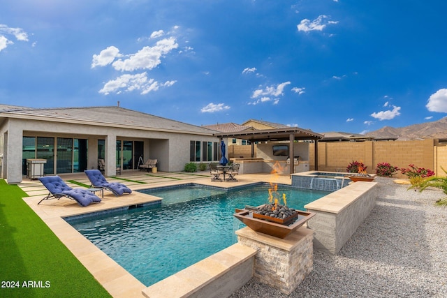 view of swimming pool featuring an in ground hot tub, a patio, and area for grilling