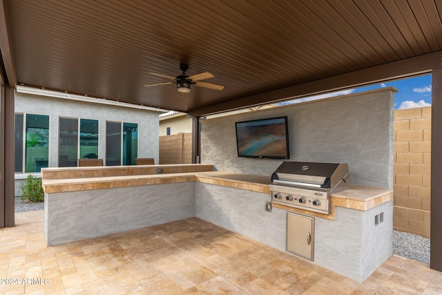 view of patio featuring area for grilling, grilling area, and ceiling fan