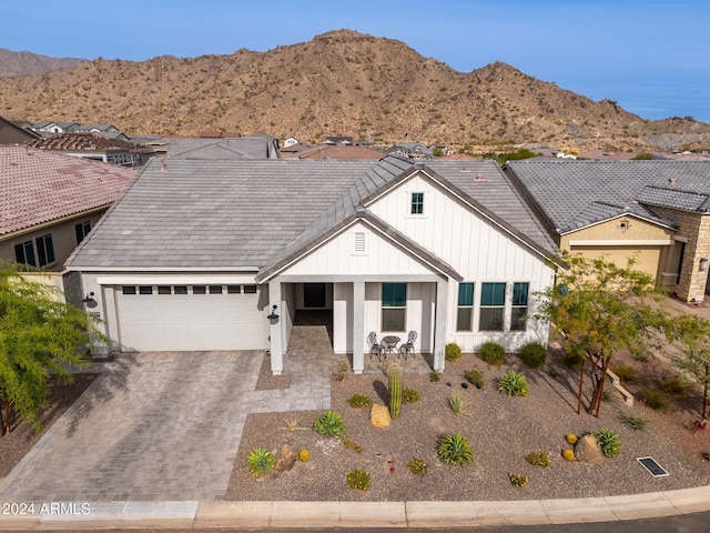 view of front facade with a mountain view and a garage