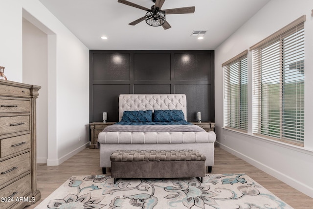 bedroom with light hardwood / wood-style floors and ceiling fan