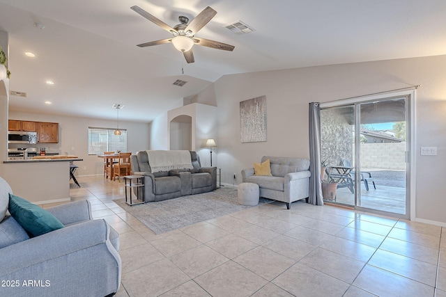 tiled living room featuring ceiling fan and lofted ceiling