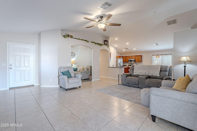 living room with vaulted ceiling, light tile patterned floors, and ceiling fan